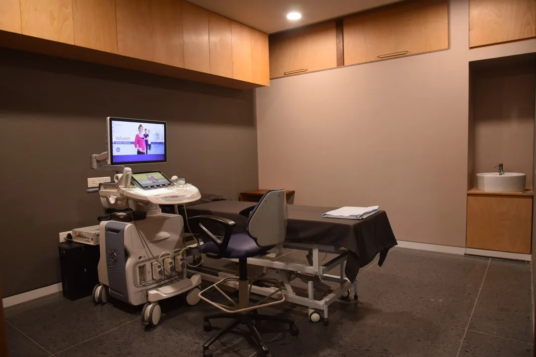 Ultrasound room with GE Voluson scanner and examination bed